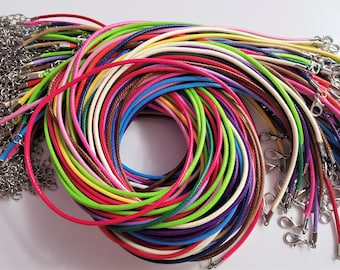 May include: A collection of colorful cords with silver clasps. The cords are arranged in a circle, with the clasps on the outside. The cords are a variety of colors, including red, green, blue, yellow, and purple.