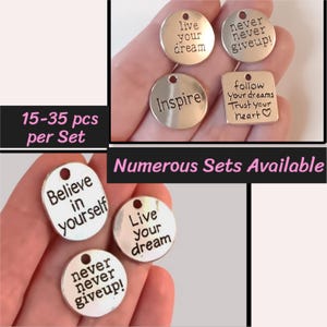 May include: Assortment of silver charm pendants with inspirational messages, including "Live your dream", "Inspire", "Believe in yourself", "Never never give up!" and "Follow your dreams, trust your heart".