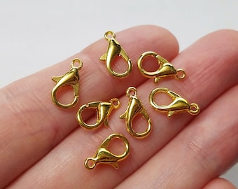 May include: Seven gold-toned metal lobster clasps, commonly used for jewelry making and crafting.