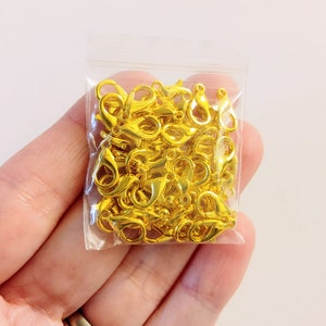 May include: A bag of gold-toned metal lobster clasps. The clasps are small and are perfect for jewelry making.