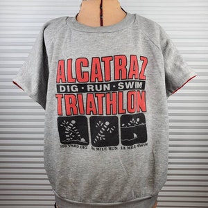 90&#39;s Alcatraz Triathlon Race Sweatshirt. XL. Short Sleeve. Dig. Run. Swim. Magic Apparel Tag. Unaffecting Aesthetic Marks. Epic History.