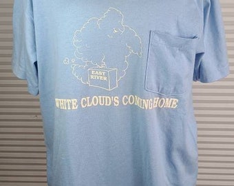 1987 Jerzees Large 'White Cloud's Coming Home' T Shirt. Cloud Graphic Personified Holding a Suitcase On Front. Stain on Back. Front Pocket.