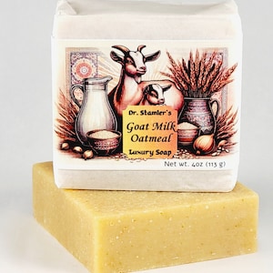 May include: A rectangular bar of goat milk oatmeal luxury soap, with a decorative label featuring a goat, a jug, and wheat. The soap is a light yellow color and weighs 4 oz (113 g).