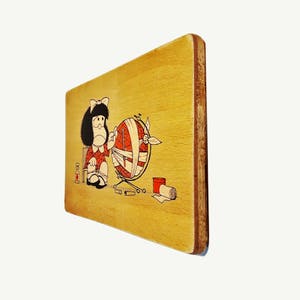 May include: A wooden plaque with a cartoon illustration of a girl holding a globe wrapped in bandages. The globe is on a stand with a small bottle and other items on the ground.