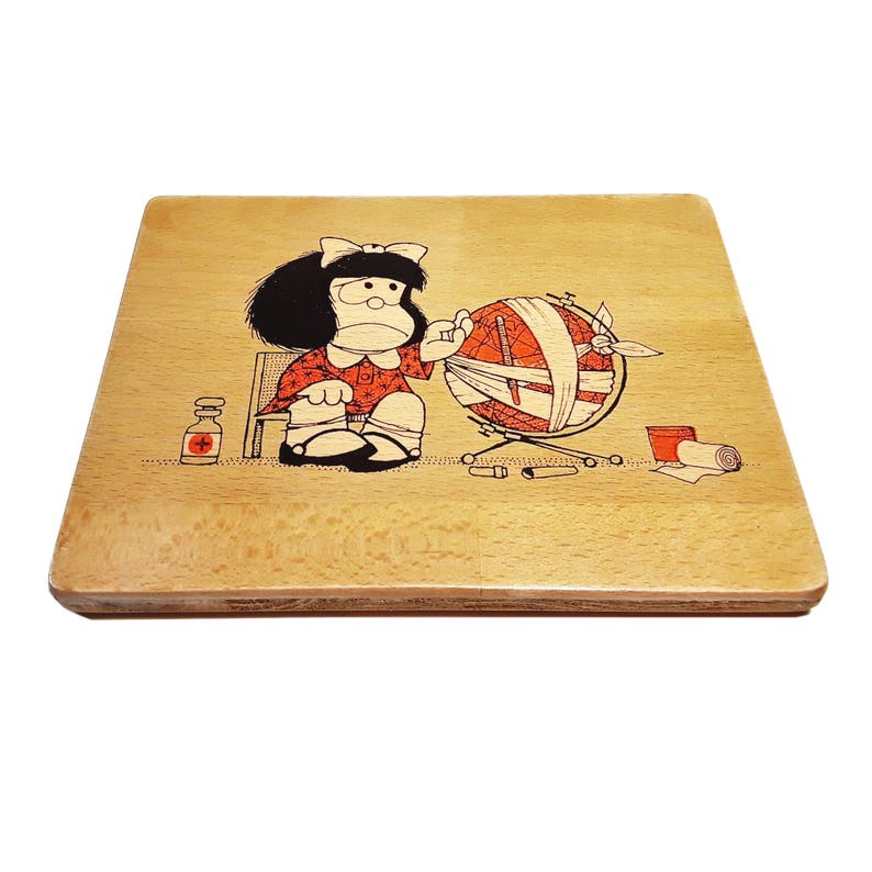 May include: A wooden cutting board with a cartoon illustration of a girl holding a globe. The girl is wearing a red dress and has black hair. The globe is wrapped in bandages.