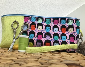 Zipper pouch, cosmetic bag, school supply bag made with manga fabric and has a wrist strap