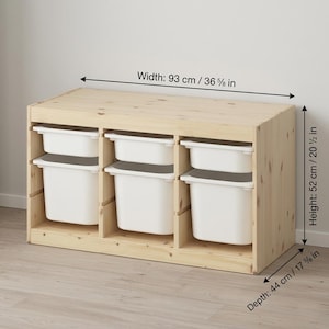 May include: A light-colored wooden storage unit with six white storage bins. The unit is 36 5/8 inches wide, 20 1/2 inches high, and 17 3/8 inches deep. Ideal for organizing toys or other items.