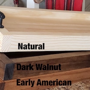 May include: Three wooden serving trays stacked on top of each other. The top tray is natural wood, the middle tray is dark walnut, and the bottom tray is early American.