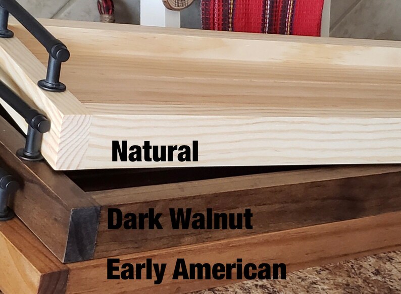 May include: Three wooden serving trays stacked on top of each other. The top tray is natural wood, the middle tray is dark walnut, and the bottom tray is early American.
