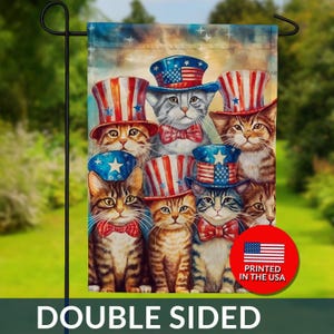 May include: A double-sided garden flag featuring a group of cats wearing patriotic top hats and bow ties. The hats display the American flag design. The flag has the text "DOUBLE SIDED" and a circular graphic that says "PRINTED IN THE USA".