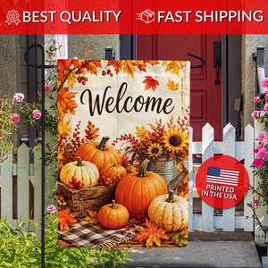 May include: A decorative garden flag featuring the word Welcome in black script, surrounded by orange pumpkins, red berries, sunflowers, and autumn leaves. The design includes a wooden crate, a metal bucket, and a black and white plaid cloth.