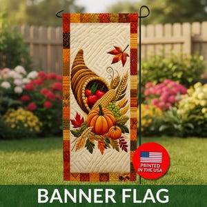 May include: A vertical garden flag featuring a quilted cream background with a central cornucopia overflowing with red apples, a yellow corn cob, green grapes, and orange pumpkins. The border consists of a patchwork of autumn-colored fabric squares.