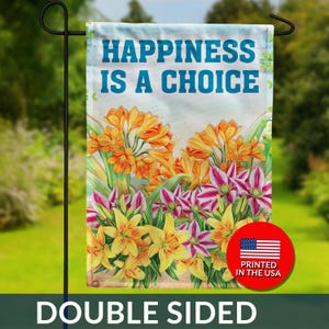 May include: Double-sided garden flag with the text "HAPPINESS IS A CHOICE" above a floral design of orange, yellow, and pink flowers. A red circle with the American flag and "PRINTED IN THE USA" is in the bottom right corner.