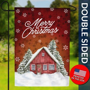 May include: Double-sided garden flag with a watercolor design. The flag features a red barn covered in snow, with evergreen trees and the words "Merry Christmas" in white. The background is a gradient of red and orange with snowflakes and stars.