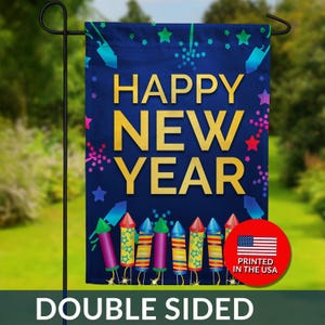 May include: A double-sided garden flag with a navy blue background and gold text that reads "HAPPY NEW YEAR." The flag features colorful fireworks and stars. A red circle with the American flag and "PRINTED IN THE USA" is on the bottom right.