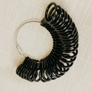 Black Ring sizer with sizes 4 to 13
