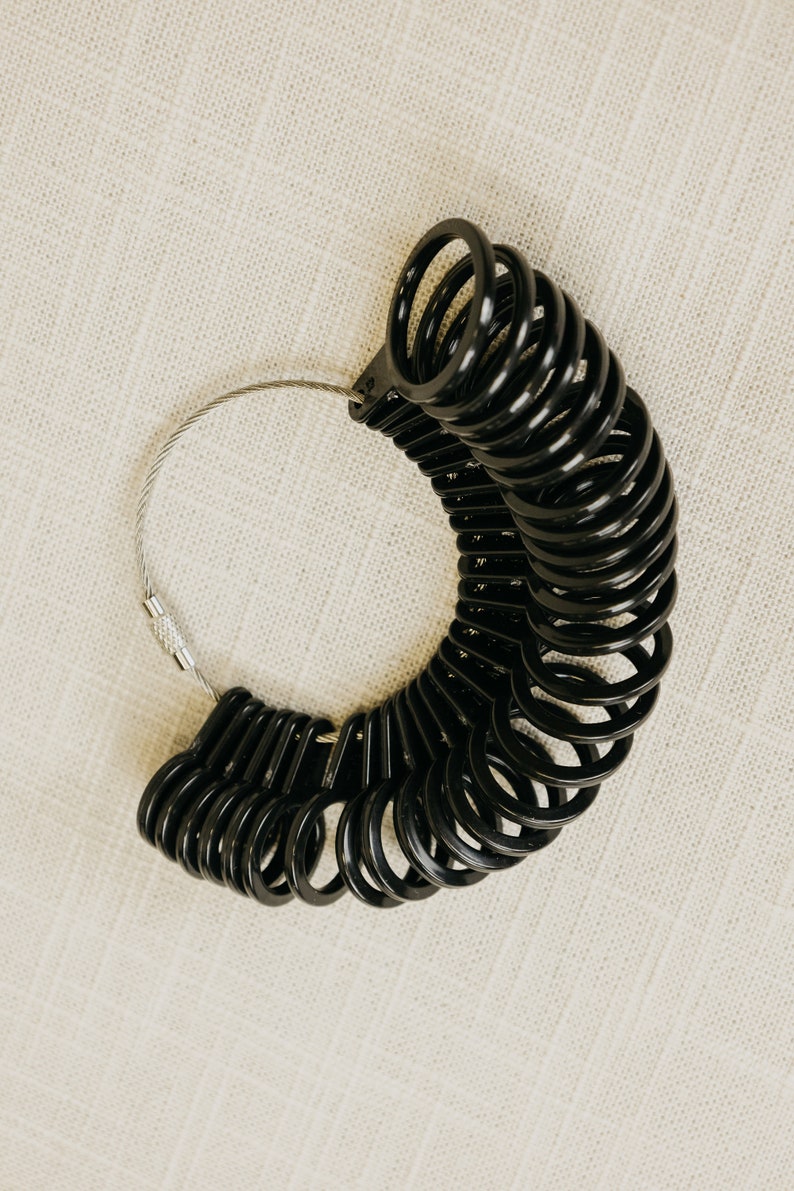 Black Ring sizer with sizes 4 to 13