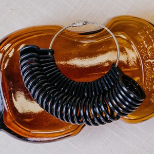 Black Ring sizer with sizes 4 to 13