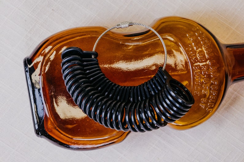 Black Ring sizer with sizes 4 to 13