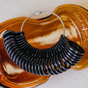 Black Ring sizer with sizes 4 to 13