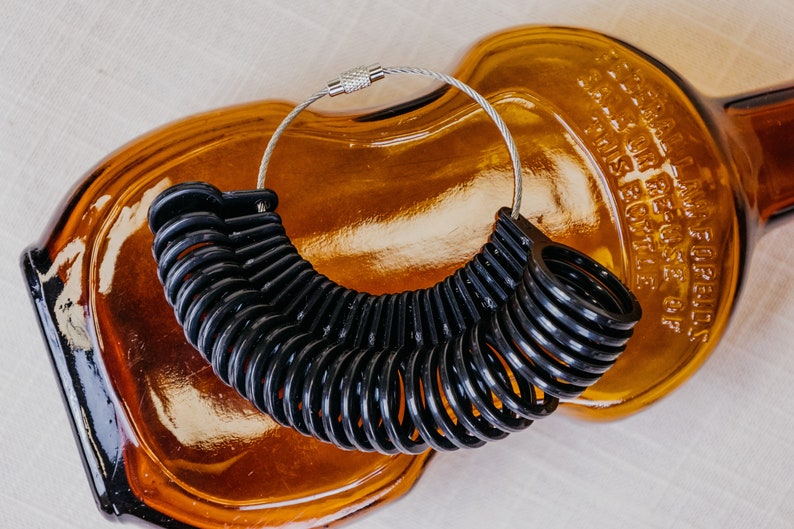 Black Ring sizer with sizes 4 to 13
