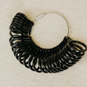Black Ring sizer with sizes 4 to 13