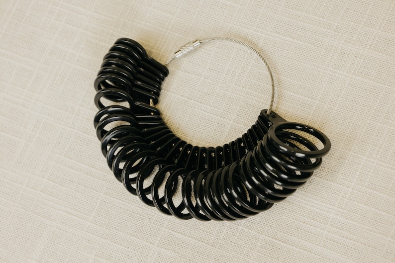 Black Ring sizer with sizes 4 to 13