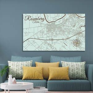 May include: A light blue map of Rosenberg, Texas, with brown lines and text. The map includes a compass rose and the text "Rosenberg, Texas".