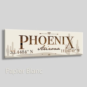 May include: A beige canvas print with a brown wood-grain design featuring the text "PHOENIX Arizona 33.4484° N 112.0740° W" with a silhouette of cacti in the background.