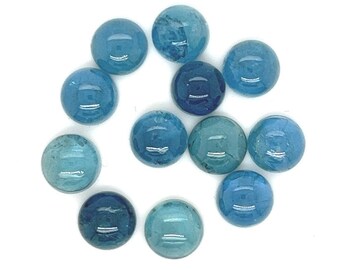 May include: A collection of 12 round, blue gemstone cabochons. The cabochons are various shades of blue, from light to dark.