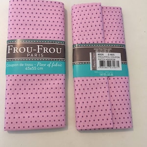 Peut inclure: Deux carrés de tissu rose à pois violets. Le tissu est étiqueté "Frou-Frou Paris" et "Coupon de tissu - Piece of fabric 45x55 cm".