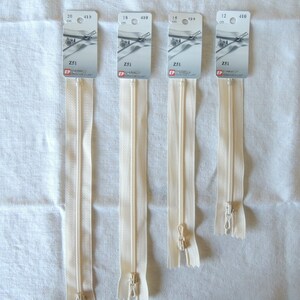 May include: Four beige zipper closures with metal sliders. The zippers are labeled with the lengths 20 cm, 18 cm, 16 cm, and 12 cm.