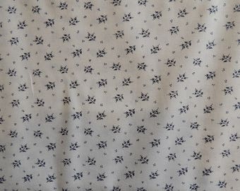 Cotton fabric coupon with white background and navy blue leaf pattern