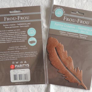 May include: Two brown packaging cards for Frou-Frou heat-transferable fabric shapes. The left card shows instructions for using the shapes. The right card shows a copper-colored feather shape.