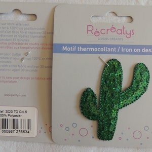 May include: Green iron-on patch of a cactus with sequins. The patch is on a white card with the text "Récréatys Loisirs Créatifs Motif thermocollant / Iron on design" and a barcode. The product reference number is 3020 TO Col. 5 and the material is 100% polyester.