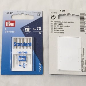 May include: A pack of 5 universal sewing machine needles, size 70, 130/705. The needles are in a clear plastic case with the Prym brand logo. The pack is blue and white with the text "Standard" and "No. 70" printed on it.