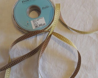 May include: A spool of brown and yellow ribbon with a chevron pattern. The spool is labeled "Frou Frou Party's".