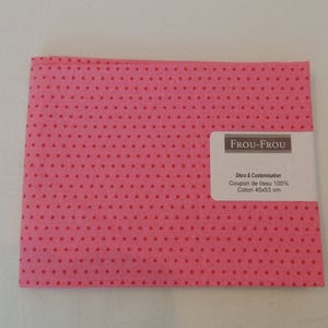 May include: Pink fabric with a white polka dot pattern. The fabric is labelled "Frou-Frou Deco & Customization Coupon de tissu 100% Coton 45x53 cm"