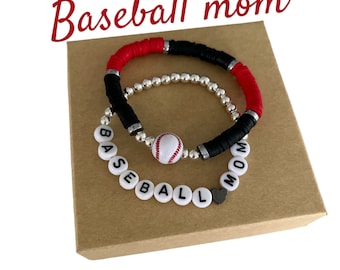 May include: Two bracelets with black and red beads, a silver bead bracelet, and a white baseball charm with the word "BASEBALL MOM" spelled out in white beads.