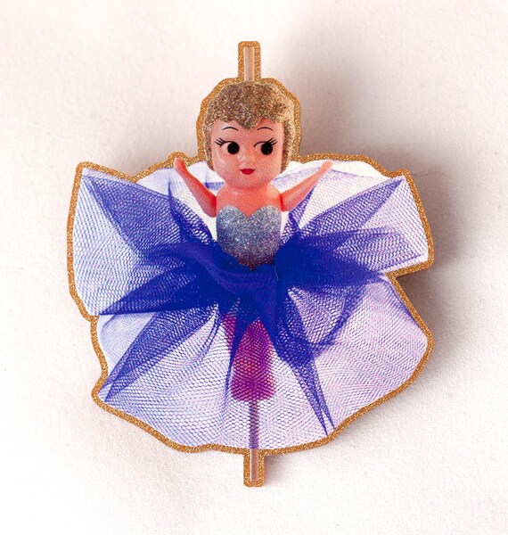 kewpie doll on stick