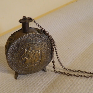 brass powder flask, powder flask, brass flask, A brass powder flask showing St George slaying the dragon 19th century,