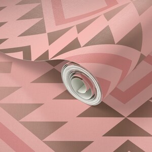 May include: Pink and brown geometric patterned wallpaper roll. The wallpaper has a subtle textured finish.