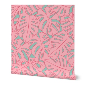 May include: A roll of wallpaper featuring a repeating pattern of pink monstera leaves outlined in a darker pink against a light teal background. The leaves have a tropical, botanical theme.
