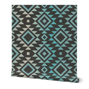 May include: A roll of wallpaper featuring a geometric pattern in shades of black, teal, and light gray. The design includes diamond and triangle shapes arranged in a repeating pattern. The wallpaper is rolled up, showing the pattern.