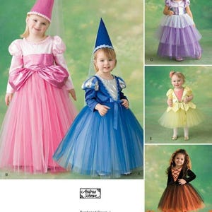 May include: A collection of children's princess and fairy costumes. The costumes include a pink dress with a cone hat, a blue dress with a cone hat, a purple dress with a tiara, a yellow dress, and a black and orange dress.