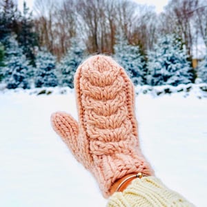 May include: A white ceramic mug with a black handle and the text "But First, Coffee" in a black, bold font. The mug is on a white surface.