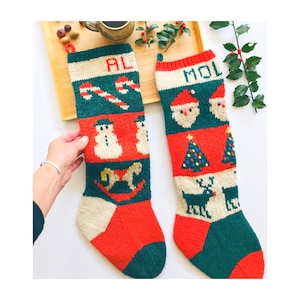 May include: Two hand-knitted Christmas stockings. One is green, red, and cream with the name "AL" and a candy cane, snowman, and rocking horse design. The other is green, red, and cream with the name "MOL" and Santa Claus, Christmas tree, and reindeer designs.