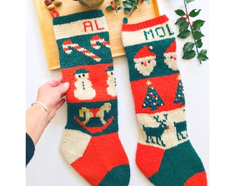 May include: Two hand-knitted Christmas stockings. One is green, red, and cream with the name "AL" and a candy cane, snowman, and rocking horse design. The other is green, red, and cream with the name "MOL" and Santa Claus, Christmas tree, and reindeer designs.