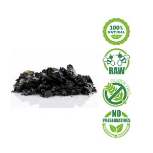 May include: A pile of black, raw, natural, gluten-free, and preservative-free charcoal. The charcoal is on a white surface. The image also includes four green and white labels with text that reads "100% Natural", "Raw", "Gluten Free", and "No Preservatives".