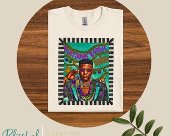 May include: Cream-colored t-shirt featuring a graphic of a man wearing sunglasses and a beaded necklace, with the text "PLAY SOME BOOSIE". The design includes a black and white striped border and festive decorations.